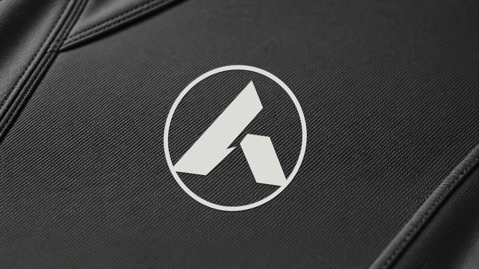 Close-up of white ANON01 embroidery on nardo grey technical fabric